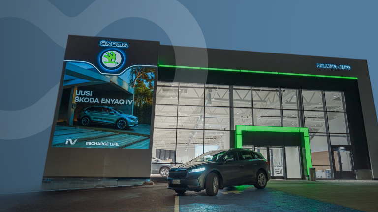 The outside of a Skoda car dealership and a car parked in front of it